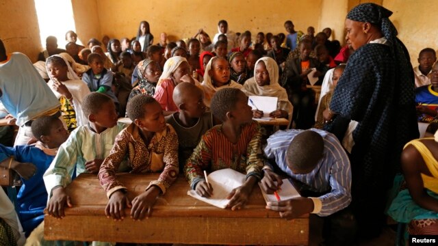 Children listen to a school teacher after the reopening of Mahamane Fondogoumo elementary school in the town center of Timbuktu, Mali, February 1, 2013.