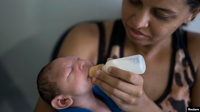 Daniele Ferreira dos Santos feeds her son Juan Pedro, who suffers from microcephaly, as they wait to be examined at the Altino Ventura Foundation, a treatment center that provides free health care, in Recife, Pernambuco state, Brazil, Feb. 4, 2016.