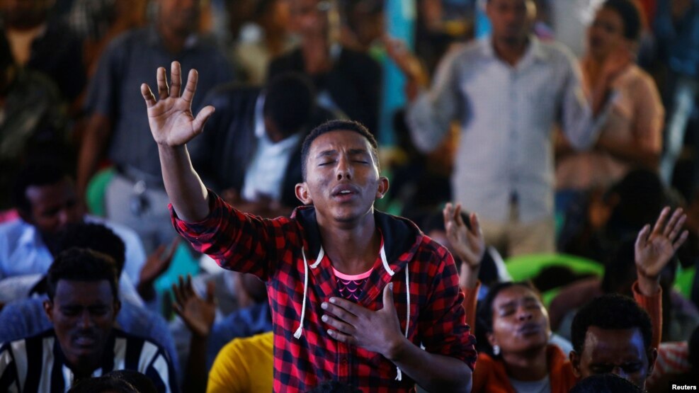 A man attends a prayer session at Biftu Bole Lutheran Church during a prayer and candle ceremony for protesters who died in the town of Bishoftu two weeks ago during Irreecha, the thanksgiving festival of the Oromo people, in Addis Ababa, Ethiopia, October 16, 2016. 