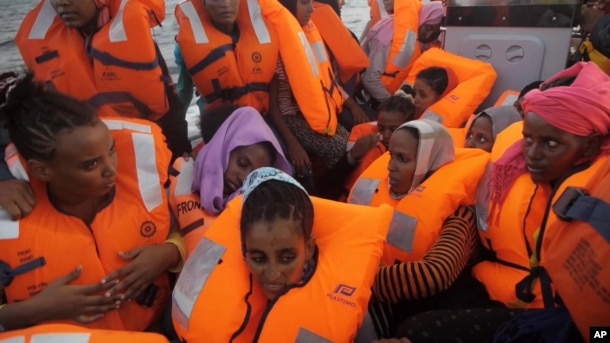 A rescue boat is filled with migrants taken from a vessel in the Mediterranean Sea off the coast of Libya in this Oct. 4, 2016 image taken from video.