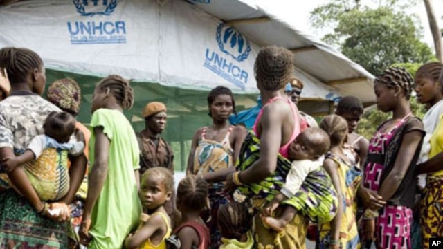 Refugees, who fled the post-election instability in Ivory Coast, wait to be registered at a camp in Liberia