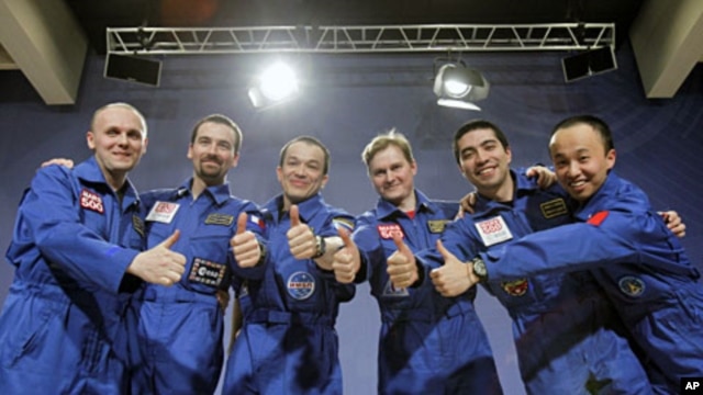 Participants of the Mars500 experiment, which simulated a 520-day flight to Mars, pose for a picture during a news conference in Moscow, November 8, 2011