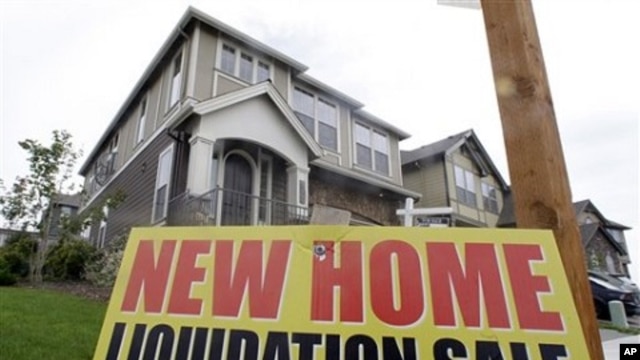 New home liquidation sign is seen in front of a home in Happy Valley, Oregon
