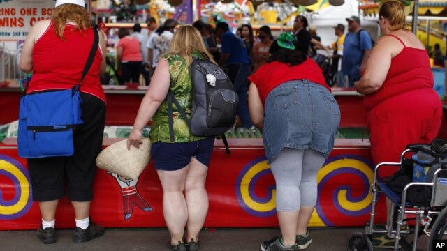 Fairgoers play a carnival game at the San Diego County Fair in Del Mar, California