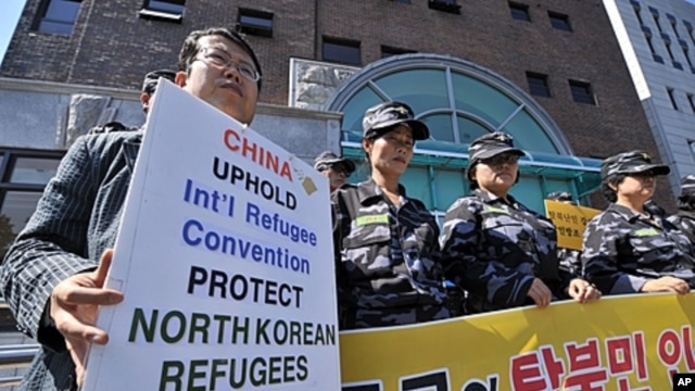 South Korean activists stage a protest outside the Chinese embassy in Seoul urging Beijing to stop repatriating refugees who flee hunger or repression in North Korea. About 30 activists including former refugees chanted slogans like "Stop forced repatriat