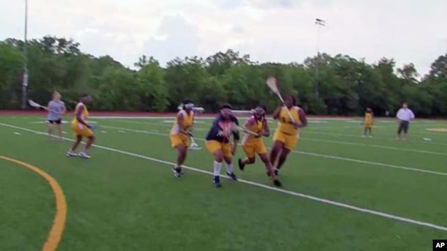 Some of the girls on the lacrosse team at Ballou High School in Washington, D.C., run a drill on the practice field, May 2011