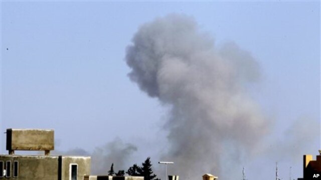 Smoke rises from an area in southeast Tripoli, Libya,  April 14, 2011