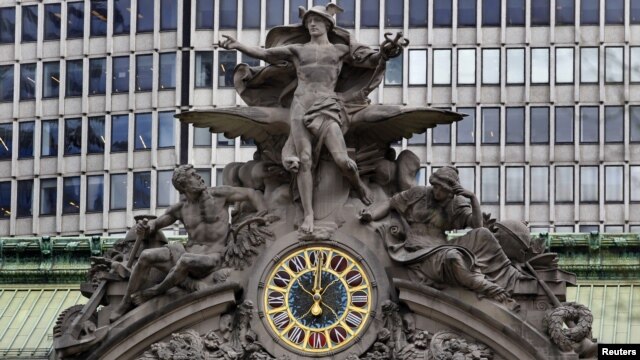 The clock on the south facing side of New York's Grand Central Terminal strikes noon March 29, 2012.