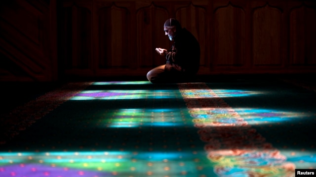 A Crimean Tatar man prays at a mosque in Bakhchysarai, Ukraine, March 10, 2014.