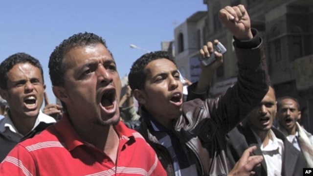 Anti-government protester shout slogans during a demonstration in Sanaa, February 15, 2011