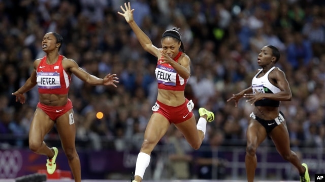 United States'  Allyson Felix crosses the finish line to win the women's 200-meters final ahead of compatriot Carmelita Jeter, left, and Ivory Coast's Murielle Ahoure, at the 2012 Summer Olympics in London.