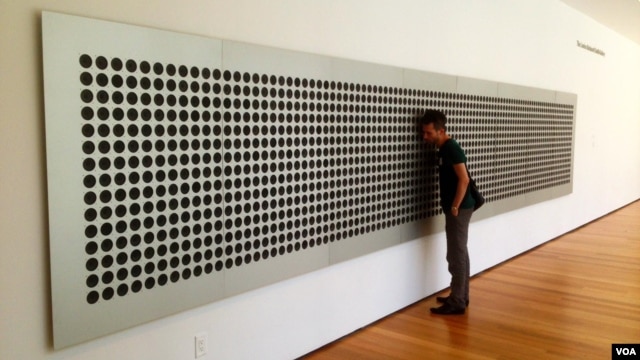 Tristan Perich's "Mictrotonal Wall" breaks down "white noise" into 1500 of an infinite number pitches that can be experienced together and in sequence by MoMA visitors. (Adam Phillips/VOA) 