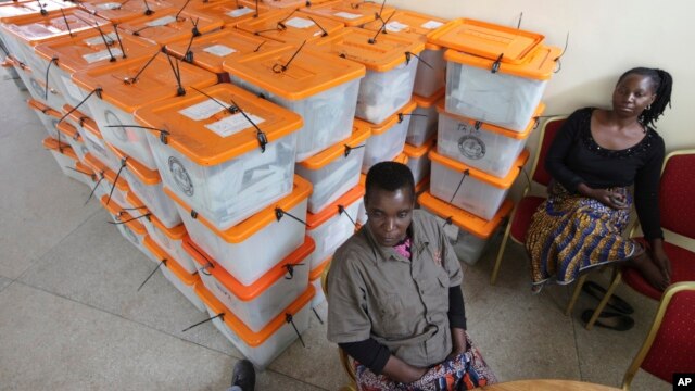 FILE - Polling station workers are seen guarding ballot boxes following presidential elections in Lusaka, Zambia, Jan. 21, 2015. Lungu prevailed at that poll, which was called to replace Zambia's late president Michael Sata.