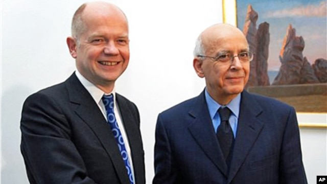 Tunisian Prime Minister Mohamed Ghannouchi, right, shakes hands with Britain's Foreign Secretary William Hague during a meeting at Carthage Palace, outside Tunis, February 8, 2011