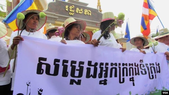 Land grabbing victims mark the 29th World Habitat Day by demanding a speedy solution to their problems. Holding a banner that reads “Voices of the Urban Poor”, they walked to the National Assembly in Phnom Penh  to submit a  petition to the government. (VOA / S. Heimkhemra)