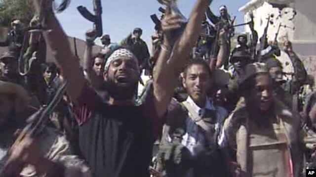 TV image shows Libyan fighters celebrating in the streets of Sirte, Libya, October 20, 2011