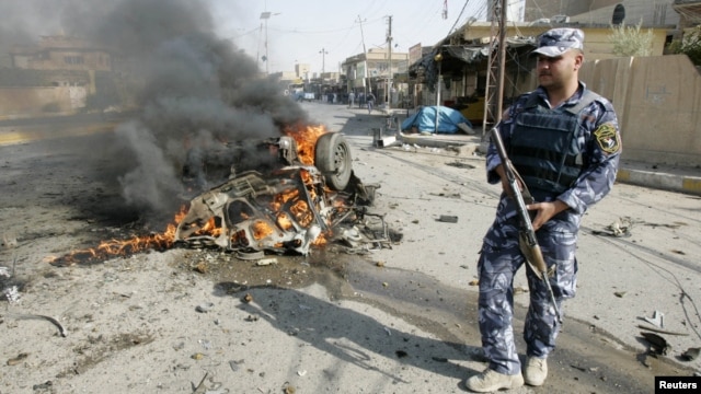 A policeman stands guard at the site of a bomb attack in Kirkuk, 250 kilometers north of Baghdad, July 23, 2012.