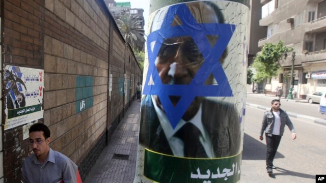 Poster created by the Egyptian Islamic Labour Party depicts former presidential candidate, and Egypt's former Vice President, Omar Suleiman, with the Star of David on his face, Cairo, April 12, 2012.
