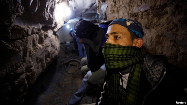 A Palestinian works inside a smuggling tunnel beneath the Egyptian-Gaza border, Feb. 19, 2013