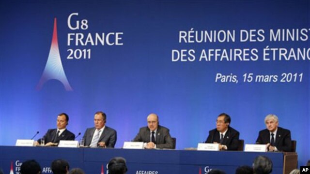 French Foreign Minister Alain Juppe, center, addresses reporters during a joint press conference held at the end of the G8 Foreign Ministers meeting in Paris, March 15, 2011