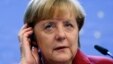 Germany's Chancellor Angela Merkel adjusts her headset during a news conference at a European Union leaders summit in Brussels Oct. 25, 2013.