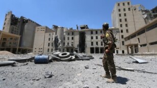 A Syria Democratic Forces (SDF) fighter walks in the silos and mills of Manbij after the SDF took control of it, in Aleppo Governorate, Syria, July 1, 2016.