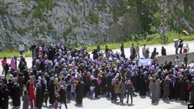 Women demonstrate on the Baida coastal highway to demand to release of those swept up in mass arrests, April 13, 2011