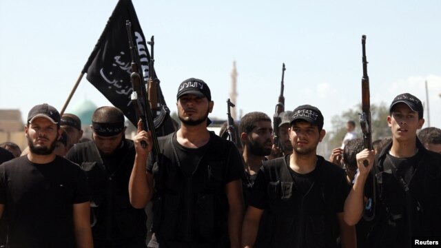 Islamist fighters carry their flag during the funeral of their fellow fighter Tareq Naser, who died during clashes on Sunday, near the village of Fafeen in Aleppo's countryside September 17, 2012.