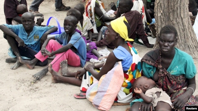  FILE - Residents displaced by fighting between government and rebel forces are seen at a World Food Program (WFP) outpost in Kuernyang Payam, South Sudan, May 2, 2015. 