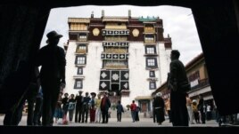 Pilgrims and tourists visit Potala Palace in Lhasa in Tibet Autonomous Region, July 5, 2006. Potala Palace, the Dalai Lama's traditional home, is more than 1,300 years old.