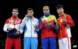 Rio Olympics Boxing: Medalists from left; Russia's Misha Aloian, silver; Uzbekistan's Shakhobidin Zoirov, gold; Venezuela's Yoel Segundo Finol, bronze; and China's Hu Jianguan, bronze; display their medals for the men's flyweight 52-kg boxing at the 2016 Summer Olympics in Rio de Janeiro, Brazil, Sunday, Aug. 21, 2016.