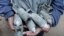 A boy holds unexploded cluster bombs after jet shelling by forces loyal to Syria's President Bashar al-Assad in the al-Meyasar district of Aleppo February 21, 2013.