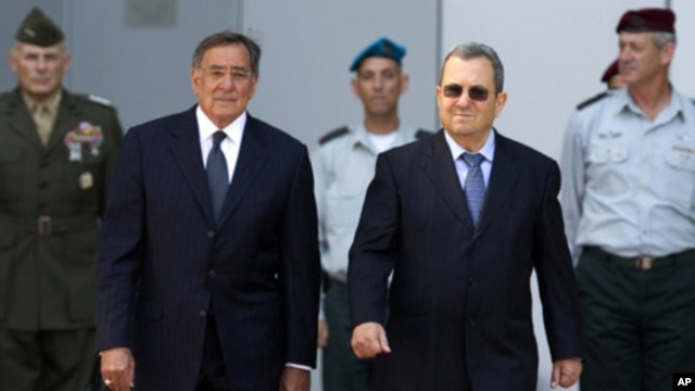 Israel's Defense Minister Ehud Barak (R) walks with U.S. Secretary of Defence Leon Panetta during an official guard of honor ceremony at the Kirya base in Tel Aviv October 3, 2011.
