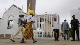 Worshipers arrive at Holy Trinity Catholic Church in Nigeria's capital Abuja, June 24, 2012. 