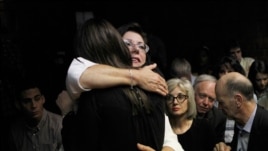 Relatives of Oscar Pistorius hug each other ahead of proceedings at the Pretoria magistrates court on Feb. 22, 2013.