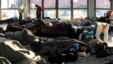 Refugees and migrants sleep inside a passenger terminal at the port of Piraeus, near Athens, Greece, Feb. 7, 2016. 