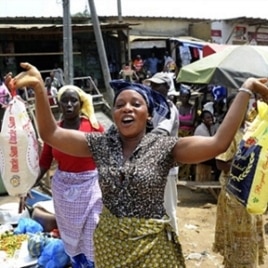 A woman holds bags of rice at a market in Abidjan. Some economists say food scarcity and rising prices could lead to social instability.