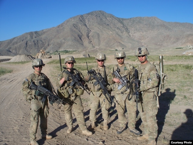 Sergeant Clayton Embre, far right, and Sergeant Devin Burgett, second from right, pose with comrades.