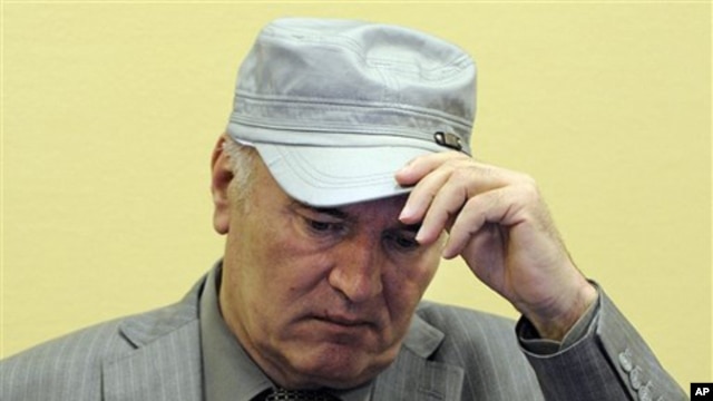 Former Bosnian Serb Gen. Ratko Mladic removes his hat in the court room during his initial appearance at the U.N.'s Yugoslav war crimes tribunal in The Hague, Netherlands, June 3, 2011.