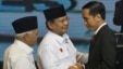 Indonesian presidential candidates Joko Widodo, right, Prabowo Subianto, center, and Subianto's running mate Hatta Rajasa greet each other during a televised debate in Jakarta, June 9, 2014