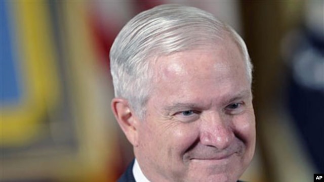 Defense Secretary Robert Gates waits for the start of a ceremony in the East Room of the White House in Washington, May 2, 2011