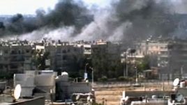 This video image taken from amateur video and broadcast by Bambuser/Homslive shows a series of devastating explosions rocking the central Syrian city of Homs, Syria, Monday, June 11, 2012. 