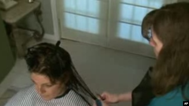 Martha Clements, who is legally blind, cuts and styles the hair of Kathy Braga, her friend and client.