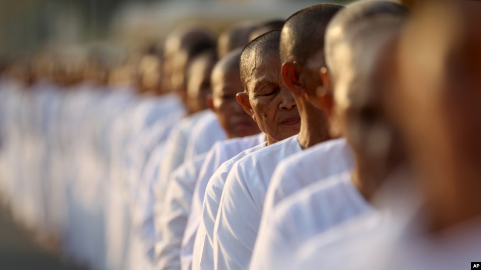 FILE-Hundreds of Buddhist nuns wait in line at the Royal Palace to pay their respects to the late former Cambodian King Norodom Sihanouk in Phnom Penh, Saturday, Feb. 2, 2013.