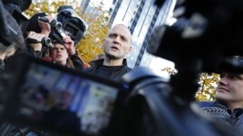 Russian opposition leader Sergei Udaltsov speaks to media after visiting the Russian Investigative Committee's office in Moscow, October 26, 2012.