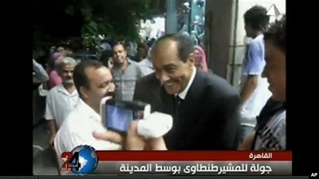 Field Marshal Mohammed Hussein Tantawi, on video seen widely on YouTube, strolls the streets of Cairo in a tailored dark suit instead of his military uniform.