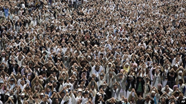 Anti-government protesters gesture during a demonstration demanding the resignation of Yemen's President Ali Abdullah Saleh, in Sanaa, Aug. 12, 2011