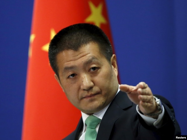 Chinese Foreign Ministry spokesman Lu Kang told reporters at a news conference that Beijing warned a U.S. Navy guided-missile destroyer that cruised close to China's man-made islands in the disputed South China Sea, in Beijing, Oct. 27, 2015.