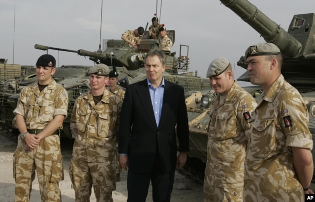 FILE- Then Britain's Prime Minister Tony Blair meets soldiers at Shaibah logistics base, Basra, Iraq, Dec. 22, 2005.