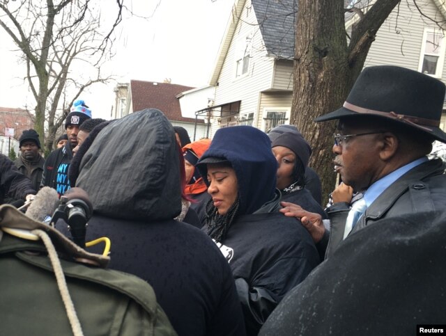 Janet Cooksey, mother of Quintonio Legrier, is consoled by relatives and friends after speaking to the media in Chicago, Illinois, Dec. 27, 2015.